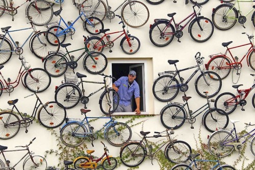 Co-owner Christian Petersen looks out of a window as he poses for the media at his bicycle shop in Altlandsberg