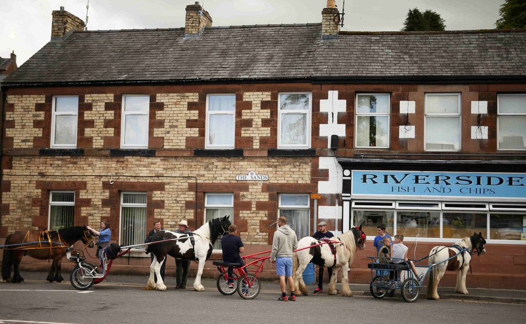Travellers park their horses and carts outside the fish and chip shop in Appleby in Westmorland