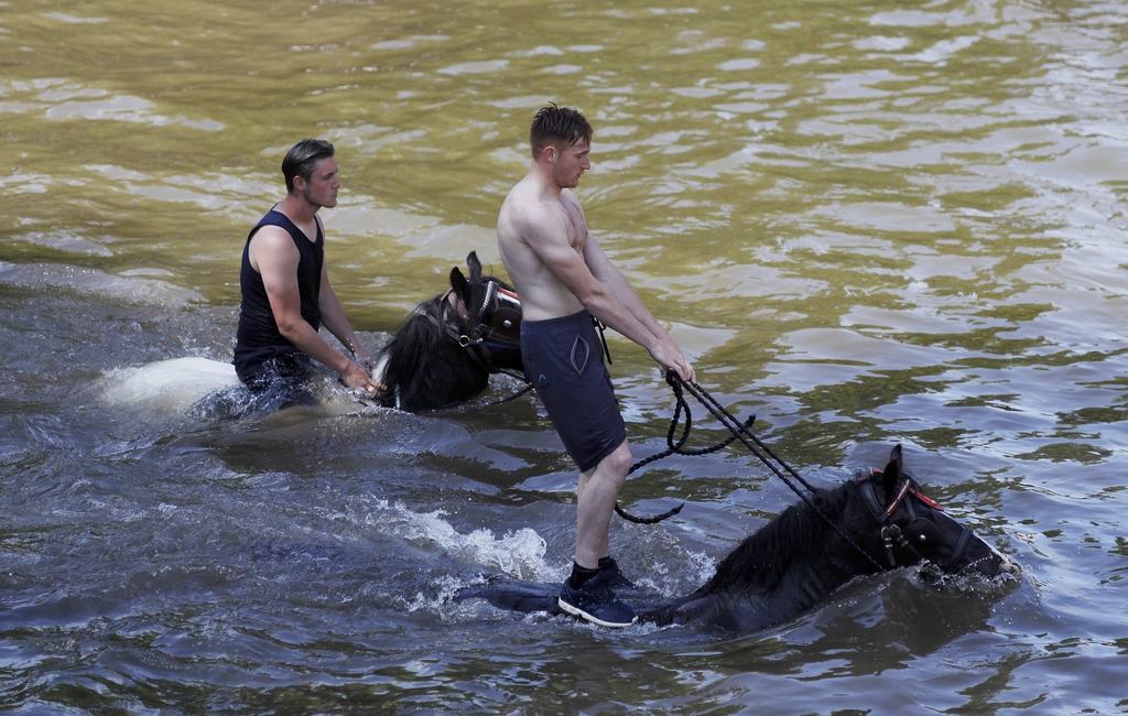 Members of the traveller community wash their horses in the river Eden during the horse fair in Appleby-in-Westmorland, northern Britain.